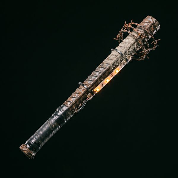 Rusty rebar club with barbed wire and an amber LED strip