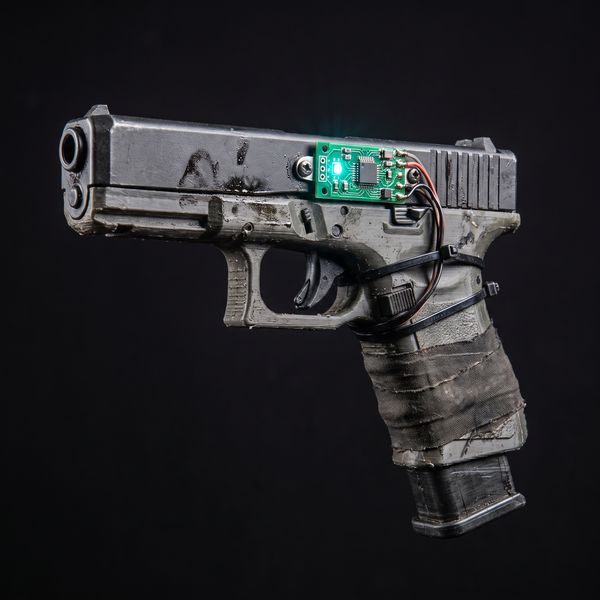 3D-printed pistol with a teal LED